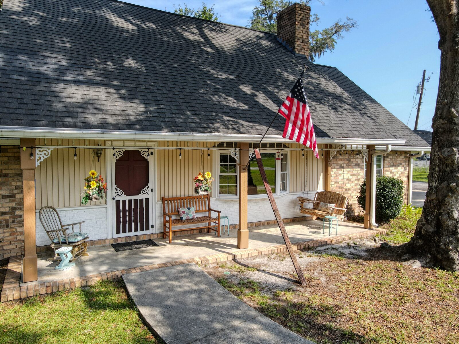 Deep covered rocking-chair front porch at 193 Grace Lane in Rincon, Georgia