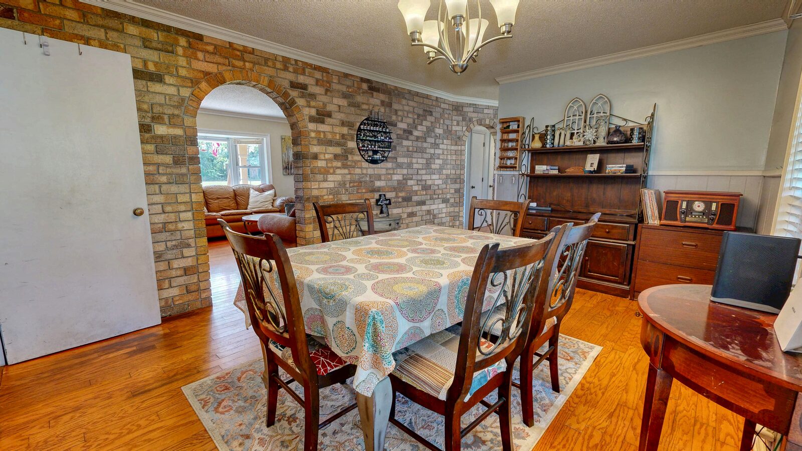 Dining room with brick archway and hardwood floors at 193 Grace Lane in Rincon, GA