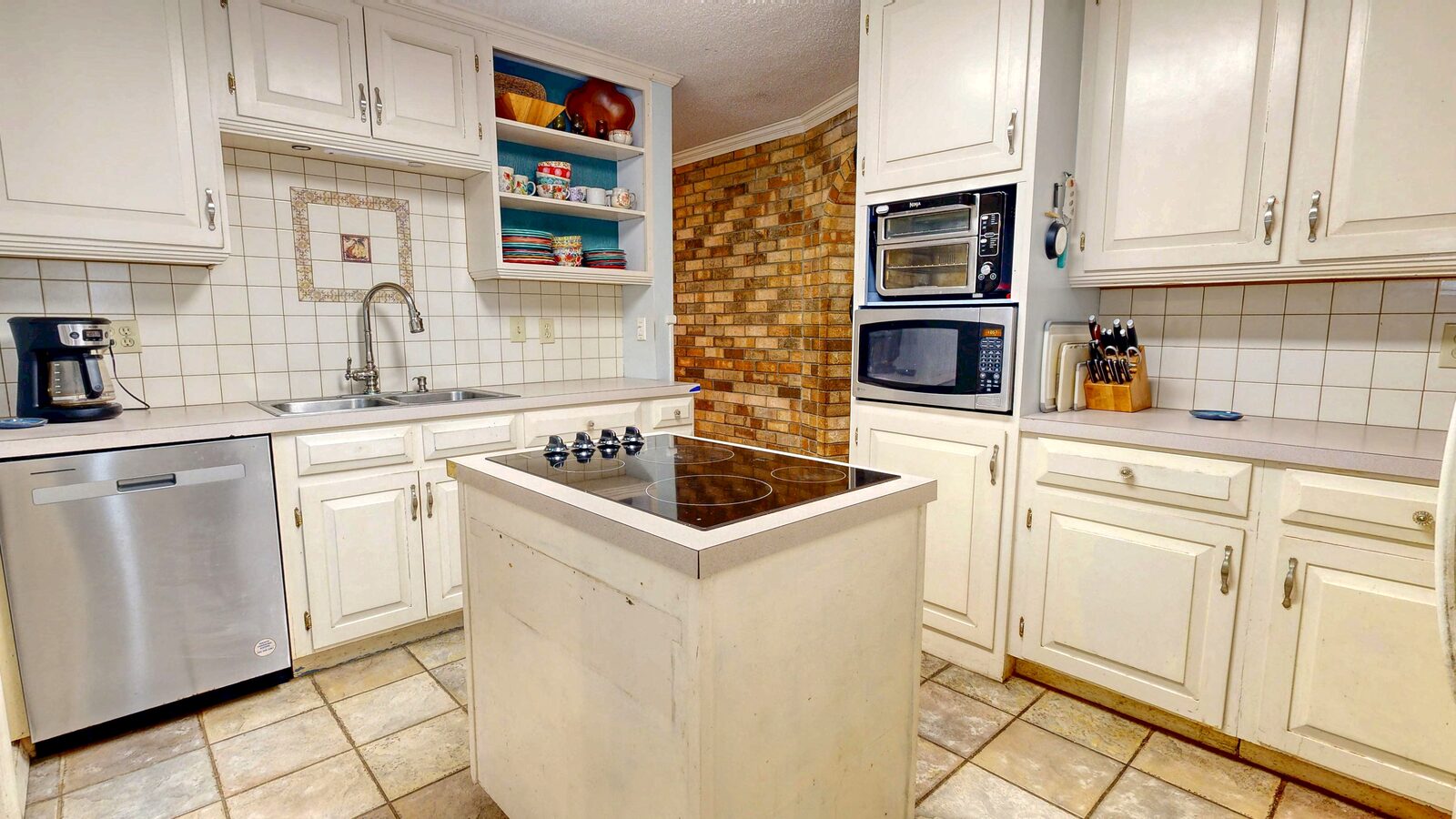Island kitchen with white cabinets and French doors at 193 Grace Lane, Rincon GA