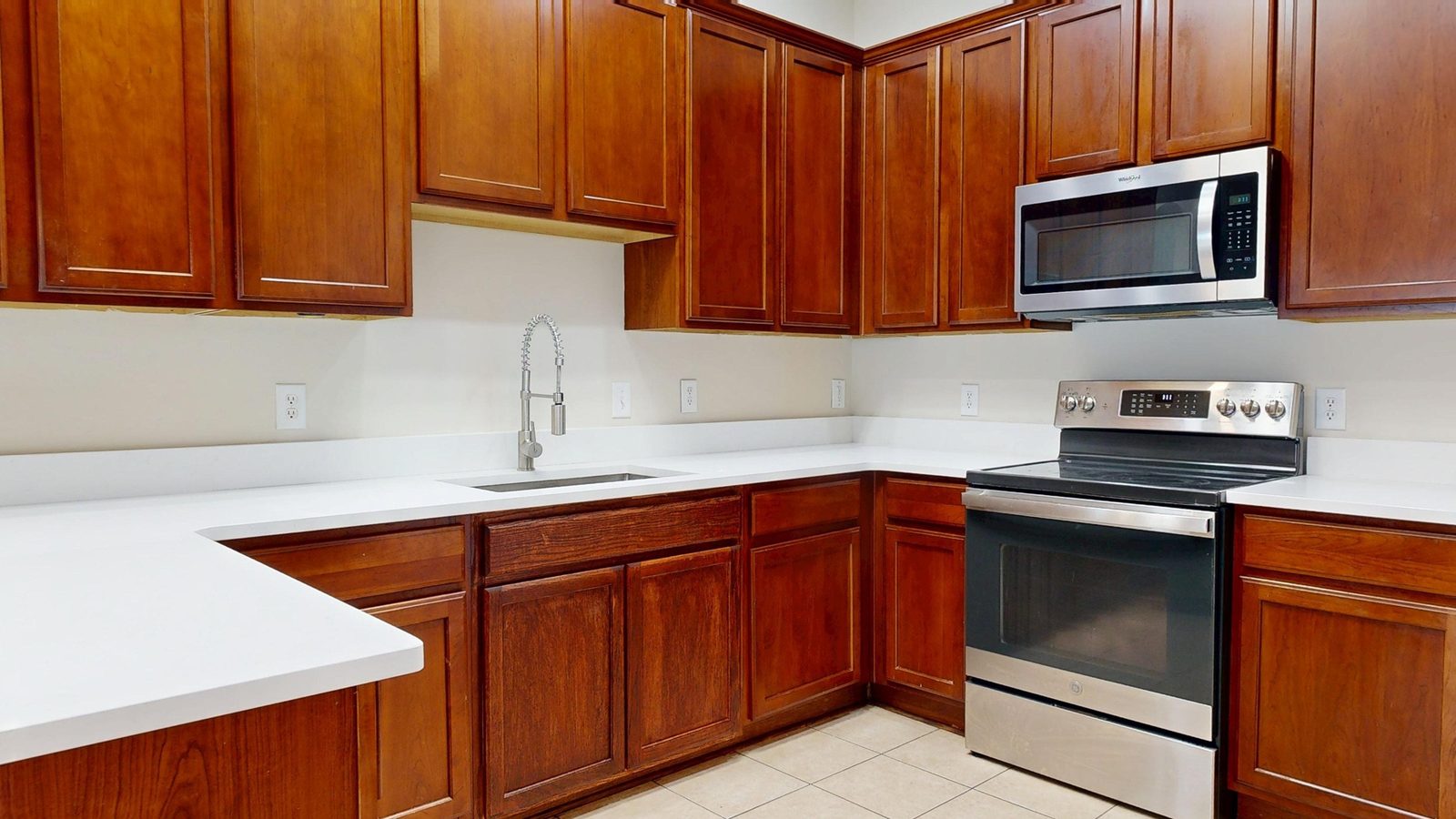 Kitchen with cherry cabinets and quartz countertops at 227 Clearwater Circle, Rice Hope