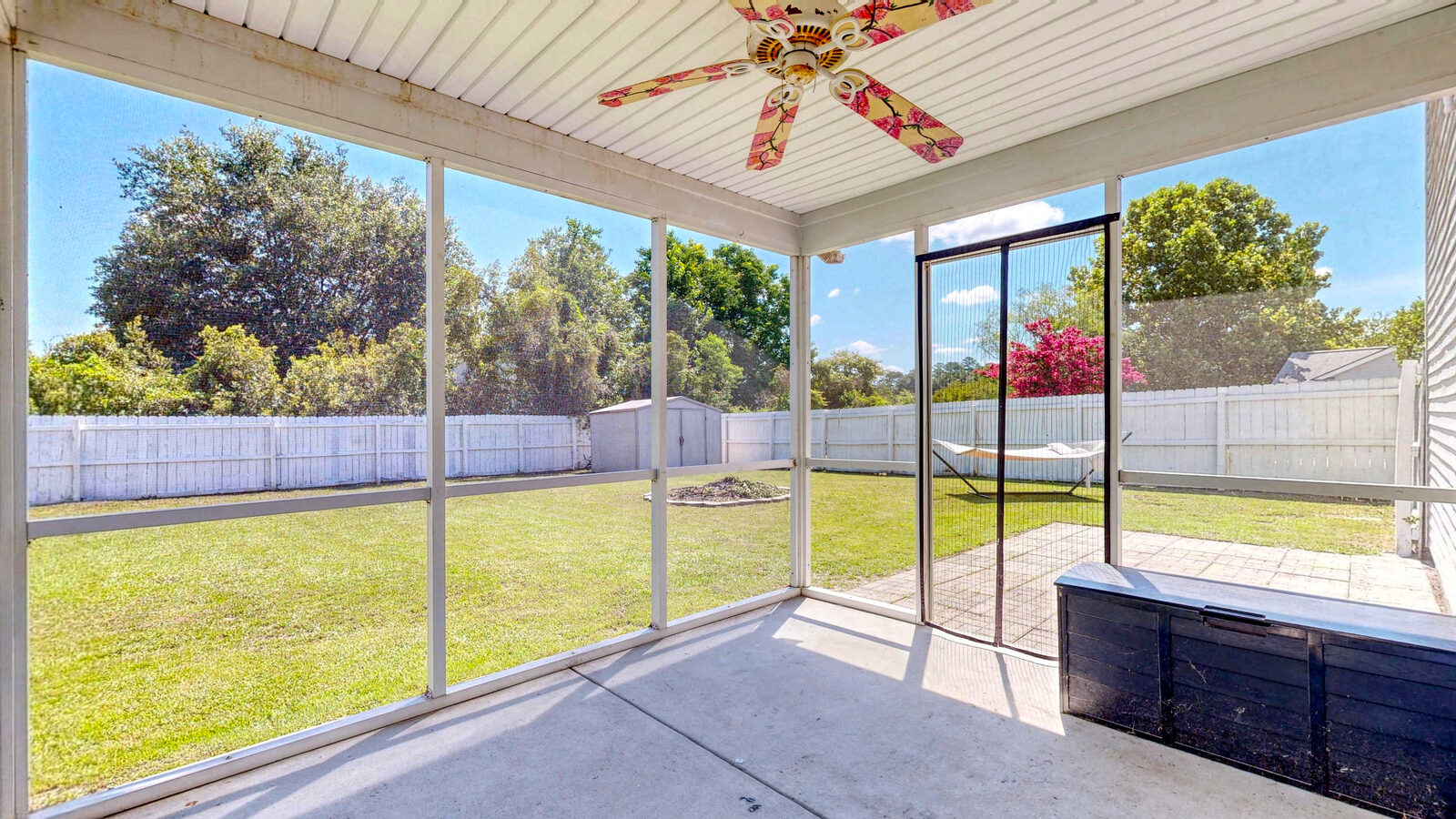 Screened-in porch overlooking the fenced backyard at 37 Hamilton Grove Dr, Savannah Quarters