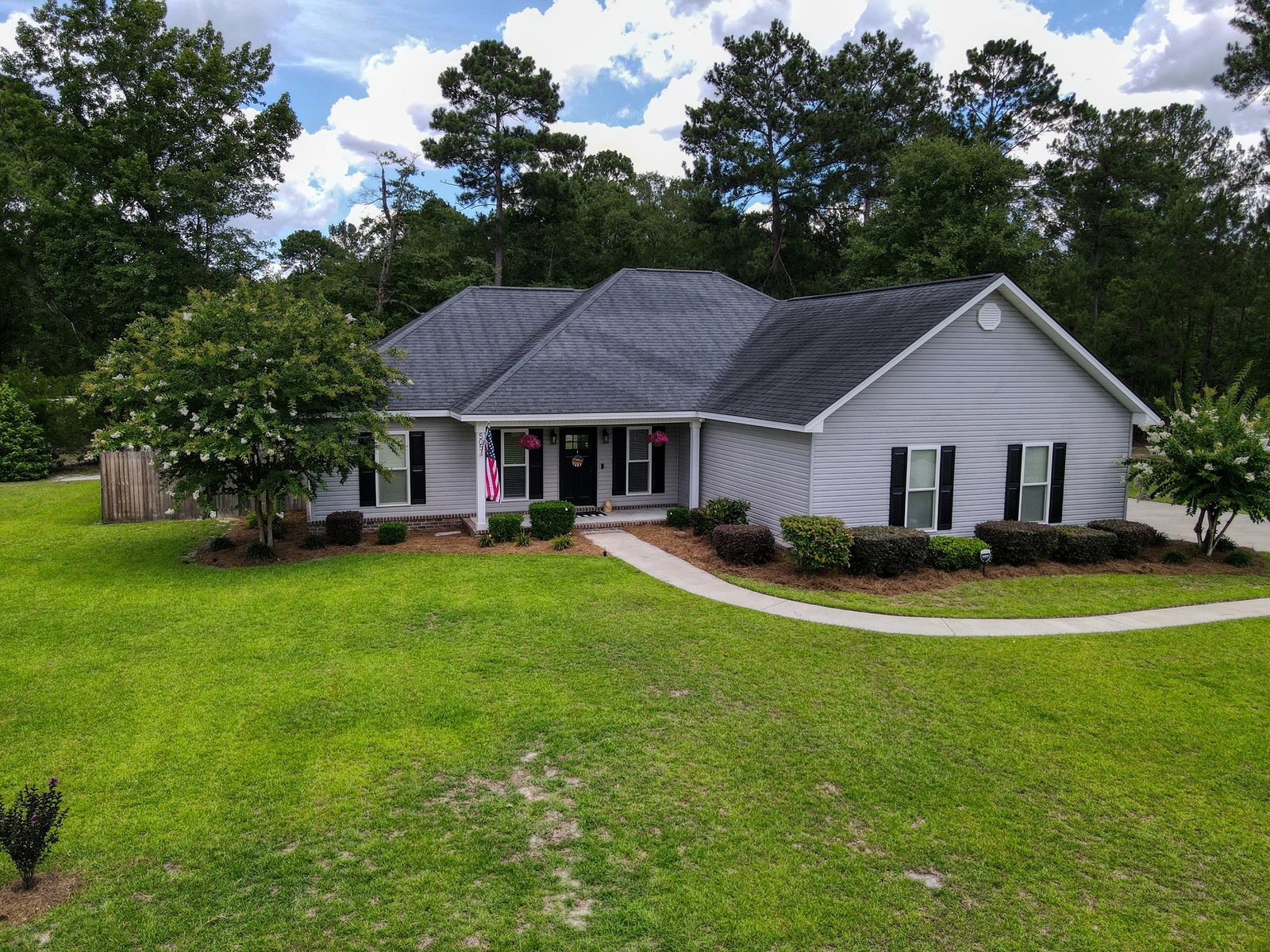 Aerial view of the wooded 1-acre lot at 505 Trinity Ave in Brooklet