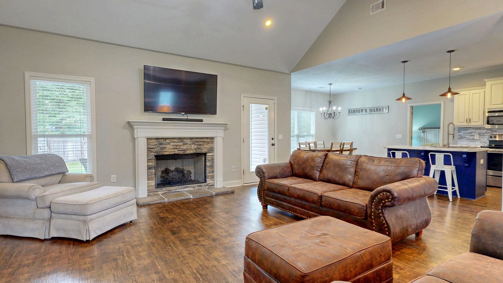 Living room with stone fireplace and vaulted ceiling at 505 Trinity Ave, Brooklet