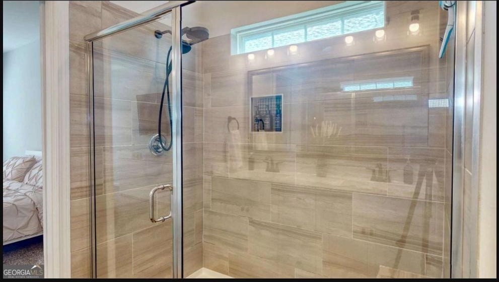 Primary bath with tiled walk-in shower at 124 Brookline Drive