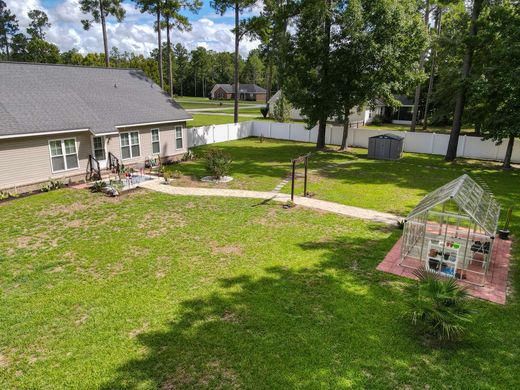 8x12 greenhouse and 5x8 storage shed in the backyard of this Brooklet GA home for sale