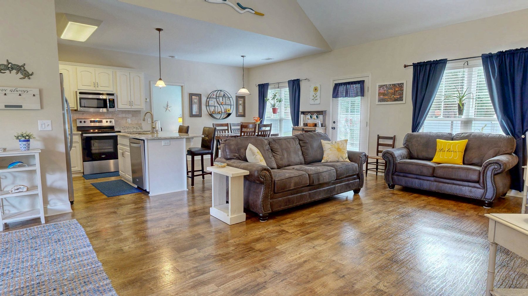 Vaulted great room with LVP flooring open to the kitchen at 124 Sugarland Blvd in Brooklet, Georgia