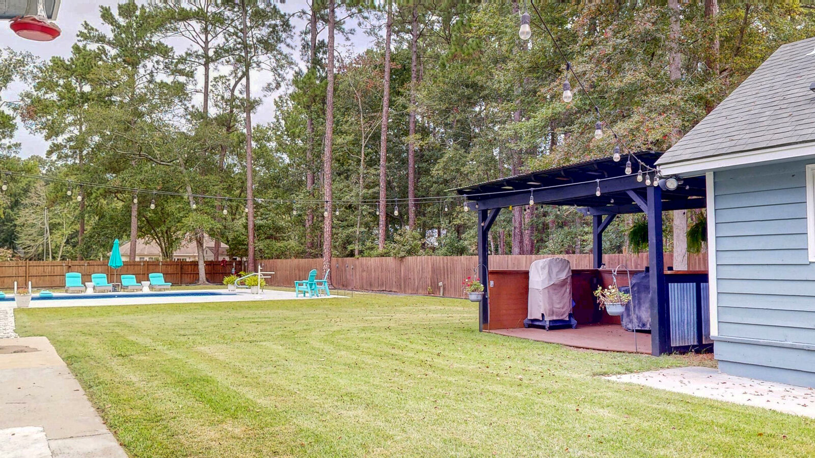 Covered gazebo with an outdoor kitchen in the backyard at 129 Palmetto Drive