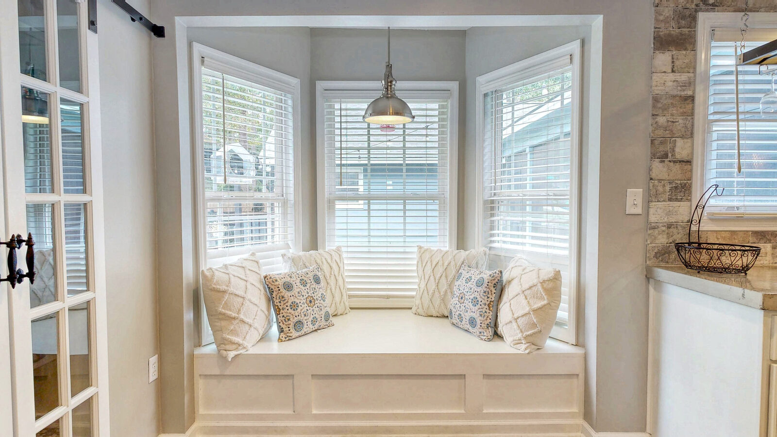 Cushioned bay window seat in the kitchen at 129 Palmetto Drive